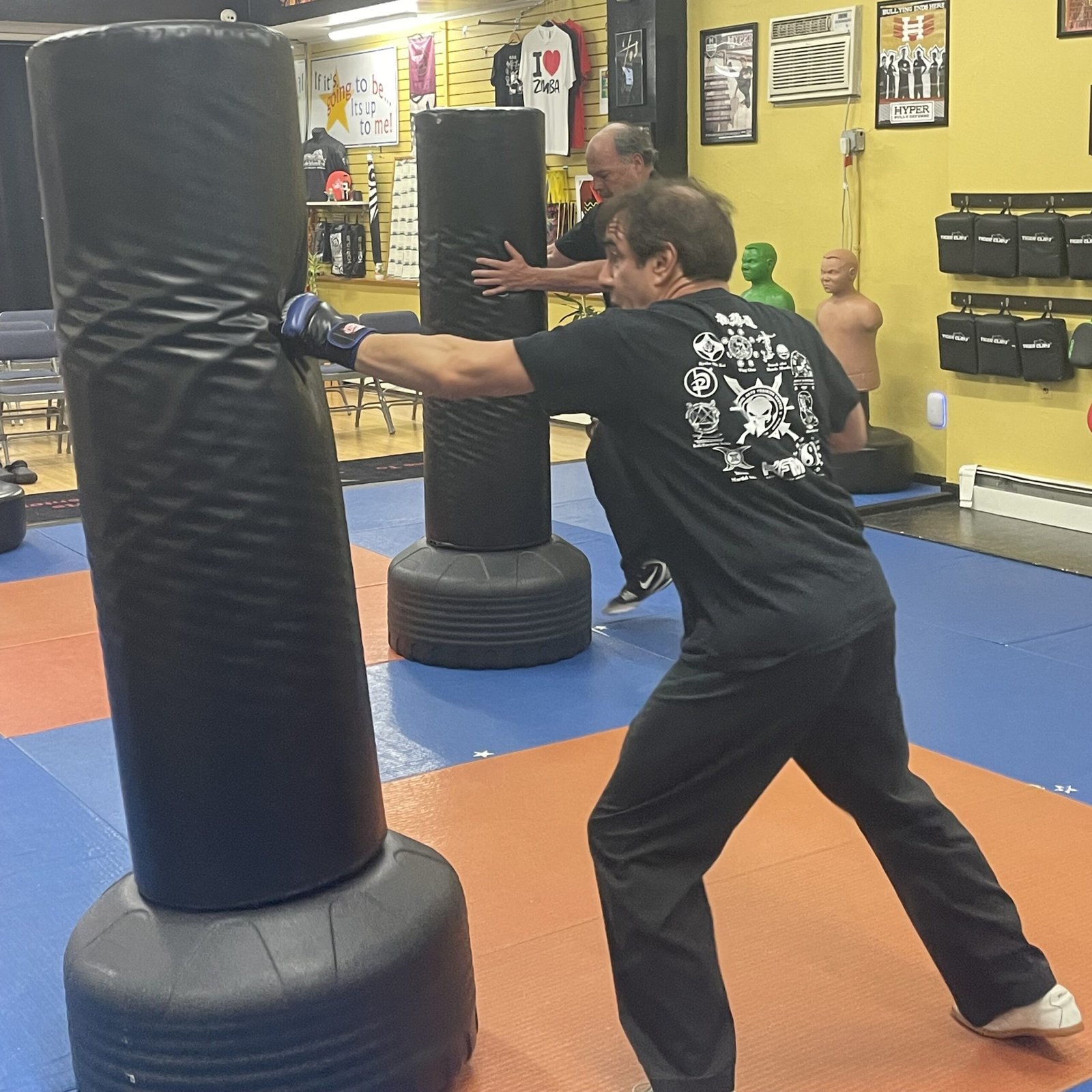 Adult student training on a punching bag
