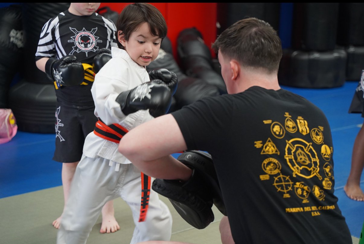 Child sparring with an instructor